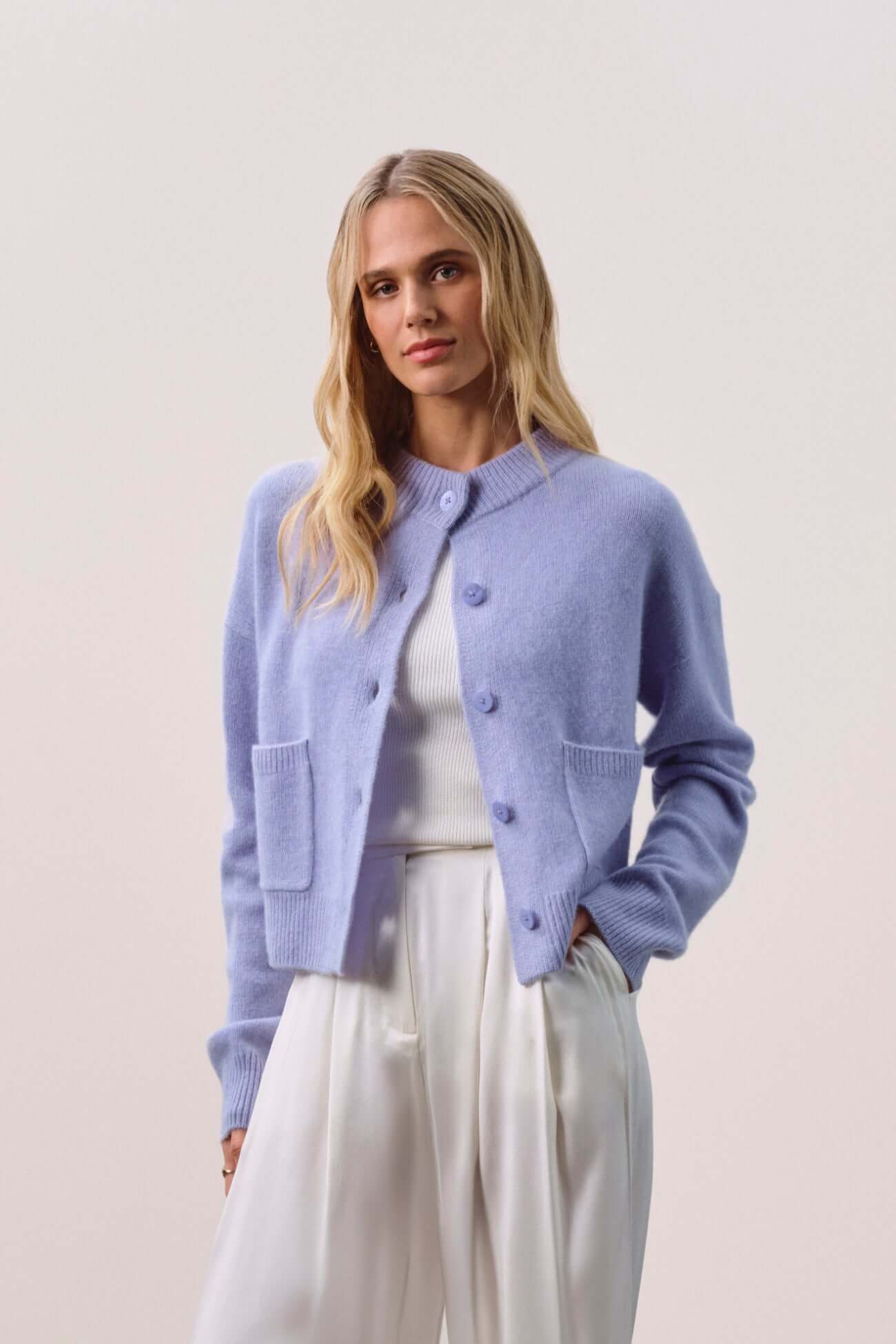 Stylish model wearing a light blue cardigan, showcasing the elegance of Cardigans in a modern outfit.